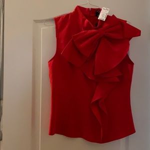Red sleeveless dress shirt bow accent.